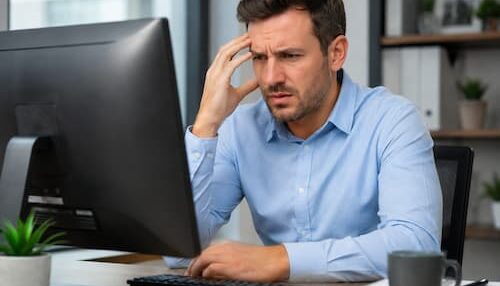 man behind computer -frustrated
